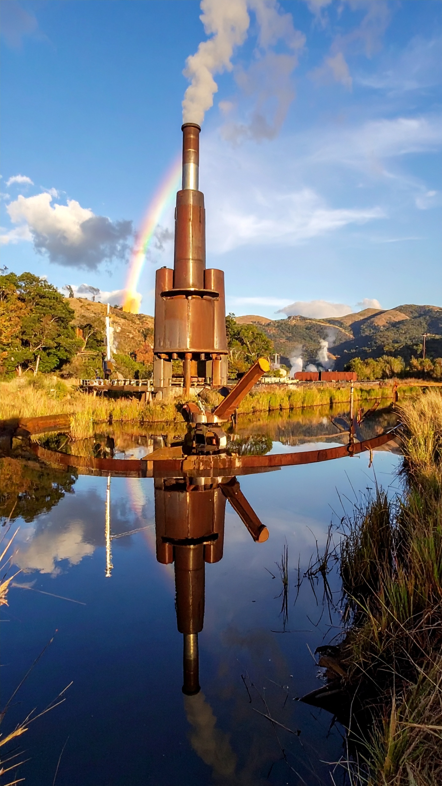 Industrial Metal Structure Reflected in Calm Water with Vibrant Rainbow